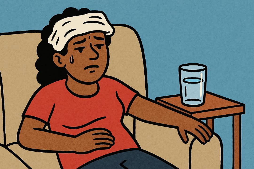 Woman treating headache with cold cloth and water.Featured Image Description:
The image shows a woman sitting on a chair with her eyes closed. A clean wet cloth is placed on her forehead. A glass of clean water is on the table near her. The background is calm and simple. This picture shows how people use simple home care for headache.Featured Image Title:
Woman Using Cloth for Headache Relief