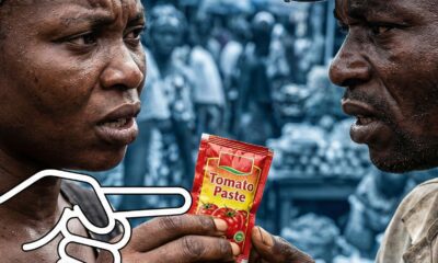 Two Nigerians in a market, one holding a tomato paste sachet while a white outline hand points at it, symbolizing the sachet economy.Featured Image Description: A close-up photograph of a Nigerian woman with a headwrap and a man in a cap, their faces tense as they hold a small tomato paste sachet. A stylized white outline hand graphic overlays the scene, pointing at the sachet. The crowded market background is heavily blurred with a cool blue tint.Featured Image Title: The Reality of the Sachet Economy in Nigeria