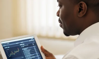 A focused Nigerian official using a tablet to monitor financial data, demonstrating how digital records stop money leakage in government offices.