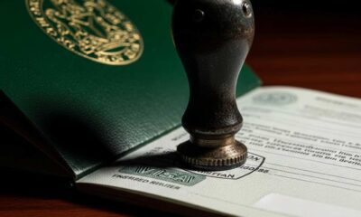 A close-up shot official ink stamp pressing onto the page open green passport.