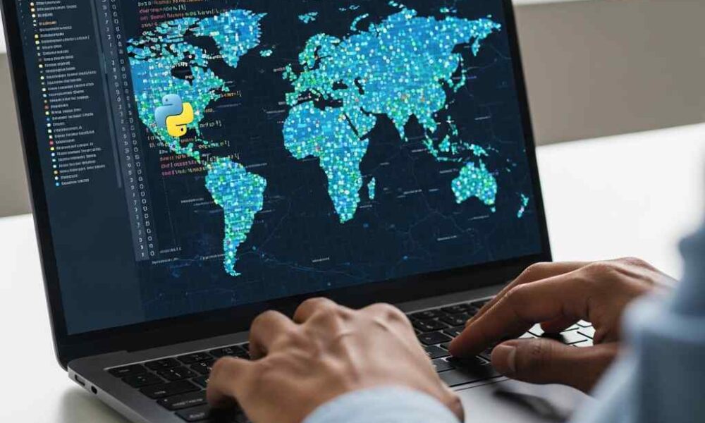 Close-up tech professional coding a digital map visualization on a laptop.