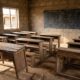 A 1:1 square photo of a desolate rural classroom in Nigeria. The wooden desks are old and dusty, some are broken, and the room is empty of students. The walls are made of weathered concrete with a cracked chalkboard at the front. Natural light streams in from a window without a frame, emphasizing the gap in rural educational infrastructure. No people or faces are visible.
