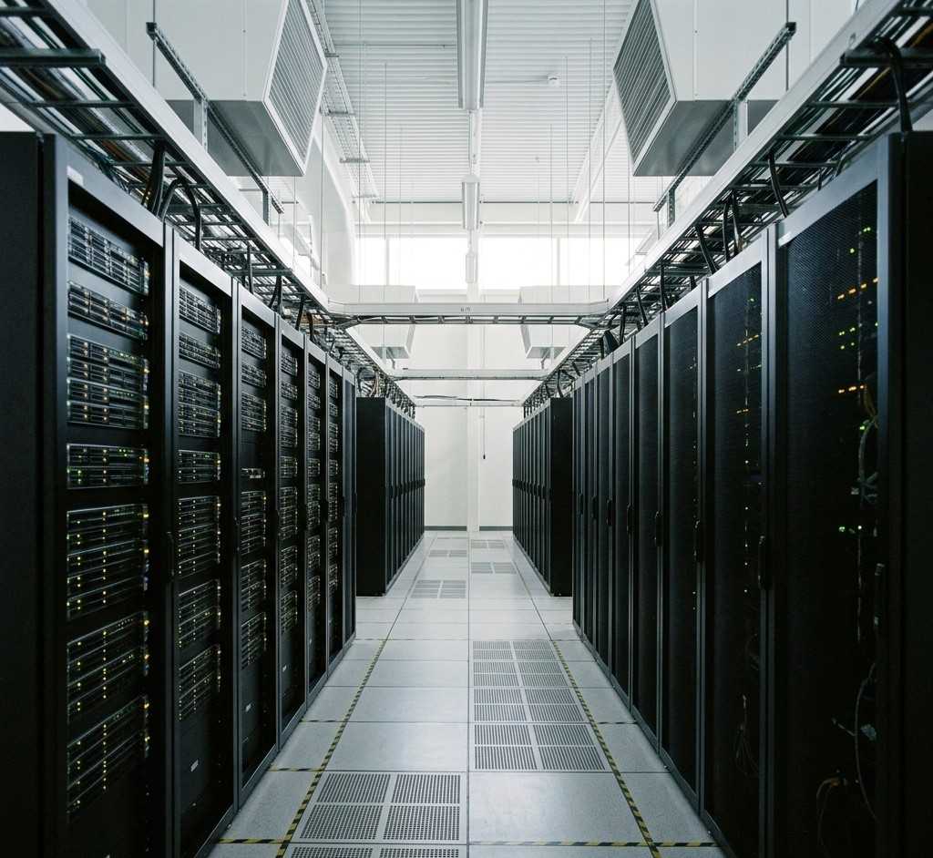Platform development showing server racks with cooling systems in data centreFeatured Image Description:
Digital photograph of a modern data centre interior showing rows of server racks with subtle indicator lights. Cooling vents visible overhead. Clean, organized layout with raised flooring. The environment conveys robust infrastructure supporting digital platforms. No people visible. Professional documentary photography style. Square composition.Featured Image Title:
platform-development-in-nigeria-server-infrastructure-data-centre.jpg