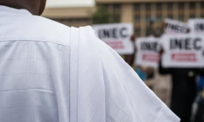 Man in white buba at Abuja protest.