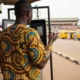 Man at phone kiosk in Lagos.