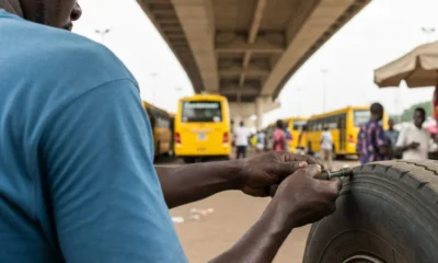 Mechanic works on tire.