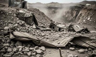 Close-up of coal-dusted hands gripping a dark rock surface at a mine entrance
