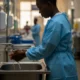 Healthcare worker washes hands in Lagos hospital.