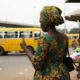 Woman at bus stop in Nigeria.