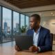 a professional Nigerian man (representing Olugbenga Agboola) seated in a sleek, modern office in Lagos. He is wearing a tailored navy blazer and focusing on a closed, minimalist laptop on his desk. The background is a clean, simplified view of the Lagos skyline under an evening sky. – Digitally synthesized: GoBeyondLocal.