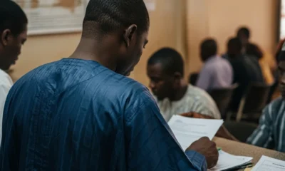 Man reviews land papers in Lagos Lands Bureau office.