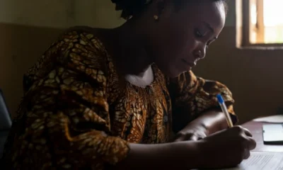 Woman in Nigeria filling out birth certificate application form