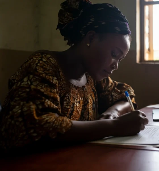 Woman in Nigeria filling out birth certificate application form