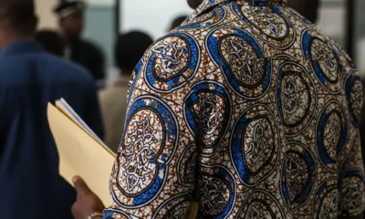 Man in Ankara shirt waits in line at FRSC office.