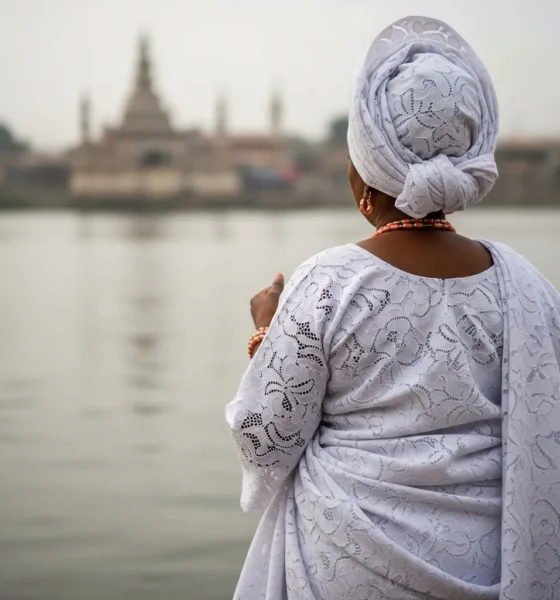 Woman in white gown at Osun River.