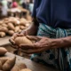 Hands hold yam in market.
