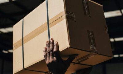 Close-up moving brown cardboard shipping boxes sunlit warehouse