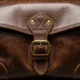 Worn leather travel bag with brass buckle