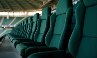 Empty green stadium seats after a match