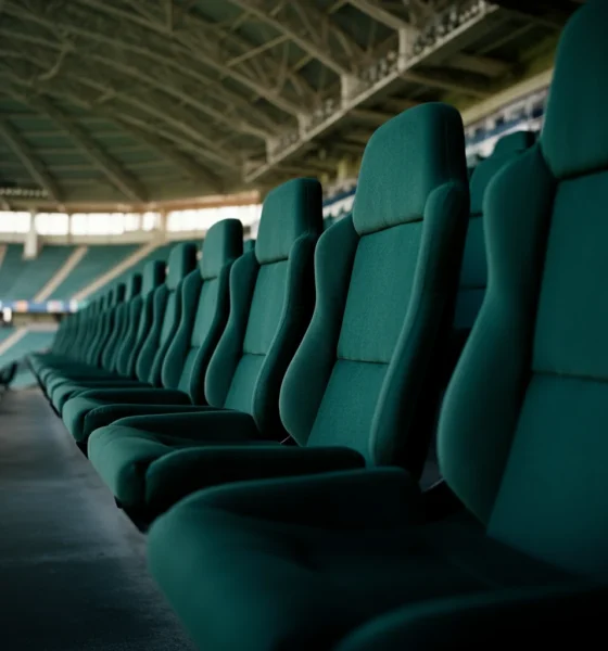 Empty green stadium seats after a match
