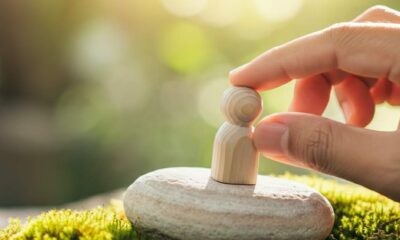 A wooden figure placed on a rock