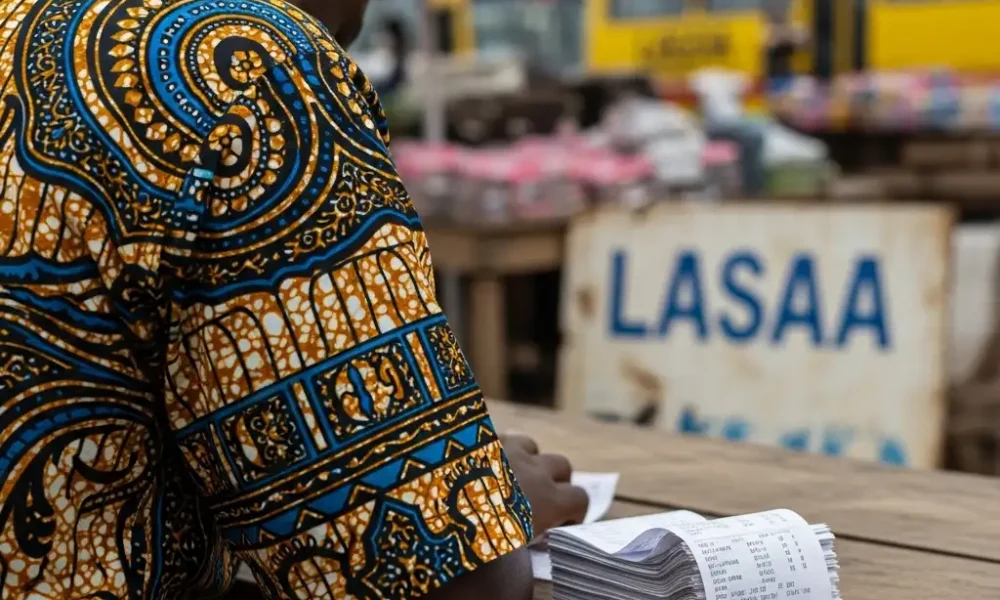 Trader with receipts at Lagos market.
