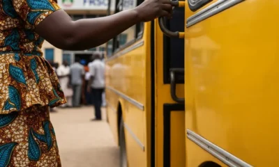 Woman by yellow bus near FRSC office.