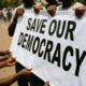 Symbolic placards at a democracy protest in Abuja