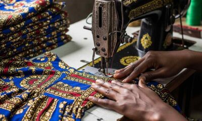 Tailor sews identical dress documentary image