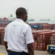 Kehinde Salami overlooks Apapa port and shipping containers.