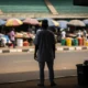 Man watches busy Warri market.